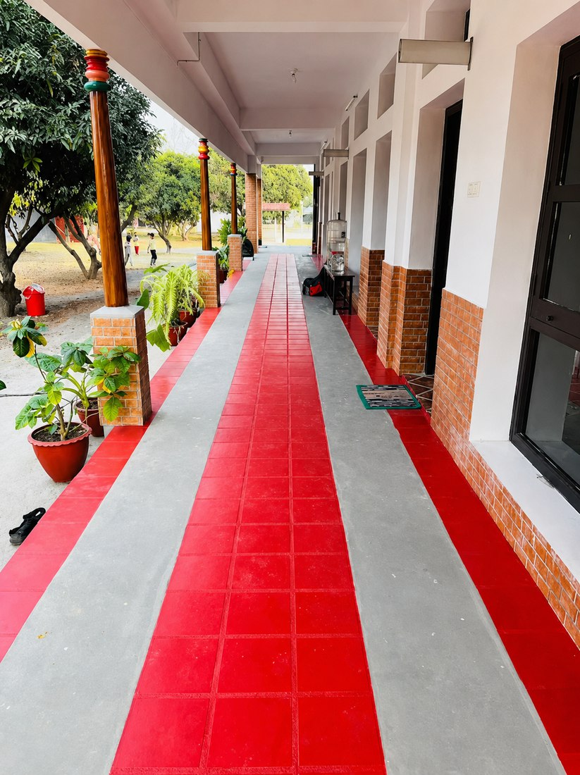 A shaded walkway along the Mango Woods School classrooms